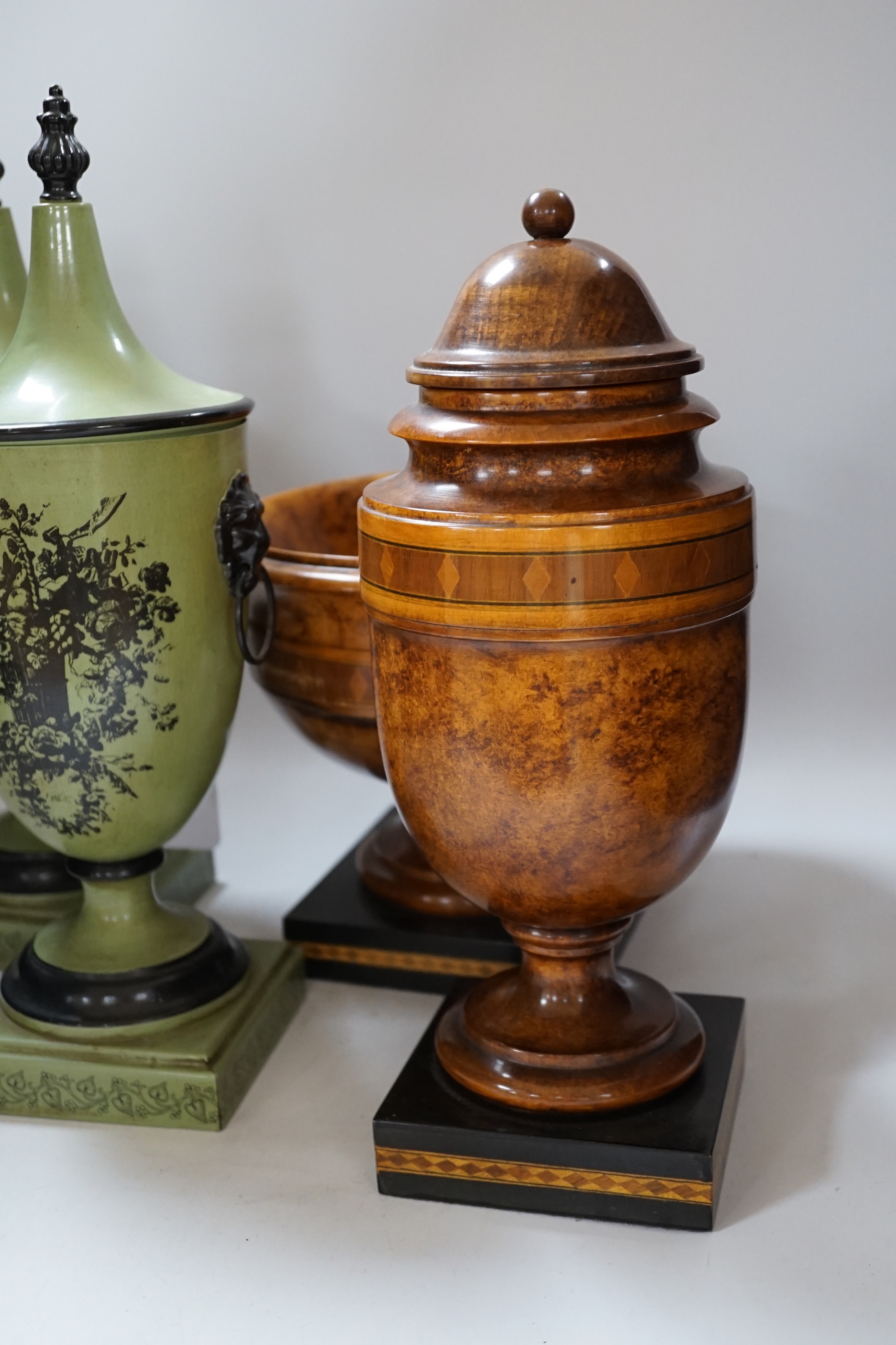 A pair of Toleware urns, a turned maple pedestal bowl and urn